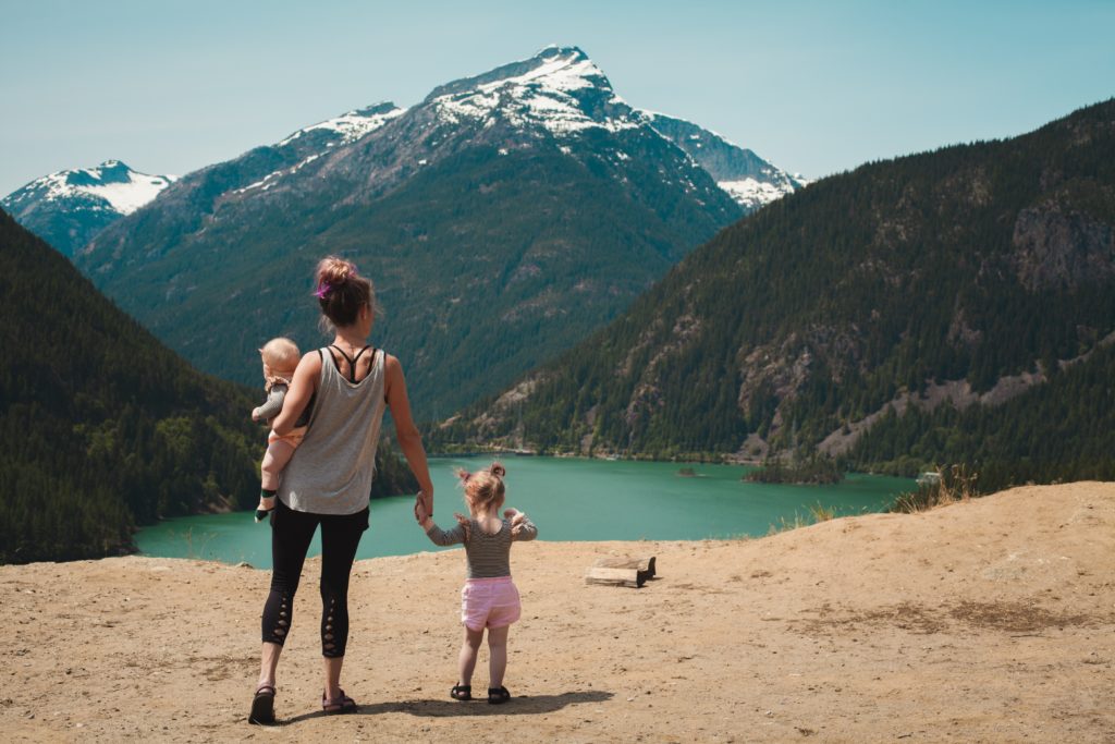 woman standing with two children